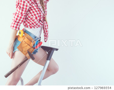 Woman with repairing tools and ladder Woman with repairing tools and ladder 127969354