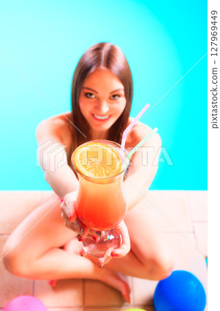 Happy woman with balloons and cocktail. 127969449