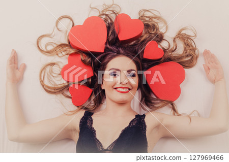 Woman in lingerie in bed. Valentines day love. Woman in lingerie in bed. Valentines day love. 127969466