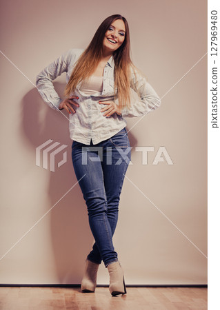 fashionable woman in shirt denim pants 127969480