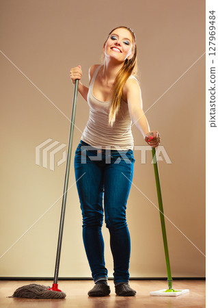 Funny cleaning woman mopping floor 127969484