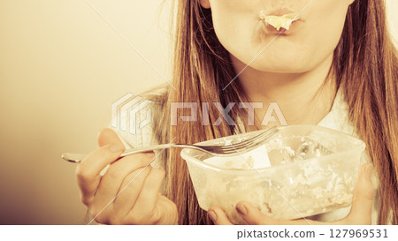 Woman eating fresh vegetable salad. Woman eating fresh vegetable salad. 127969531