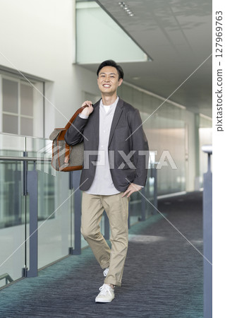 A man in his early 40s smiling at the camera 127969763