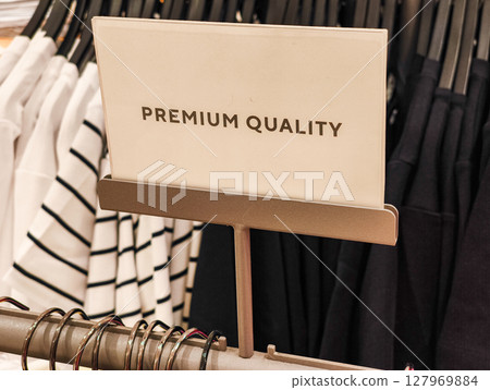 Premium quality sign displaying in clothing store Premium quality sign displaying in clothing store 127969884