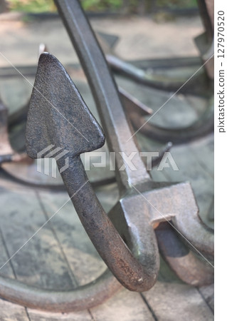 Old historical ship anchor. old rusty anchor. 127970520