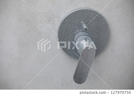 Dirty calcified shower mixer tap, faucet with limescale on it, plaque from water, Chrome-plated shower, close up photo 127970750