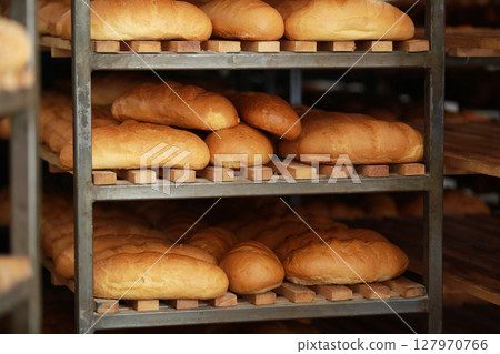 baked fresh bread on shelf. buns from the oven. Baking bread. Transportation of baking. Confectionery. baked fresh bread on shelf. buns from the oven. Baking bread. Transportation of baking. Confectionery. 127970766