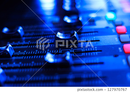 Concert sound mixer panel with volume regulators. Professional audio and light equipment for sound recording studio, live music broadcasting, television, party. mixing console. audio signals Concert sound mixer panel with volume regulators. Professional audio and light equipment for sound recording studio, live music broadcasting, television, party. mixing console. audio signals 127970767