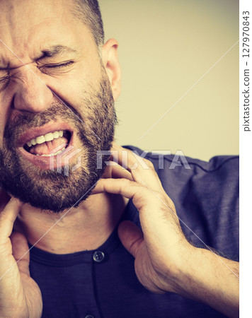Man having throat, neck pain 127970843