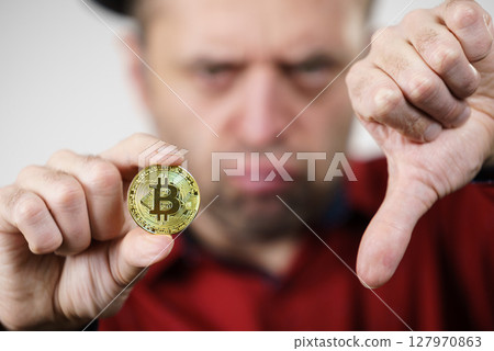Man having bitcoin coin 127970863