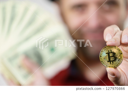Man having bitcoin coin and cash 127970866