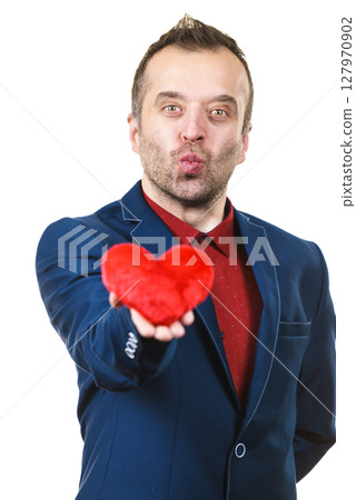 Man in suit holding heart Man in suit holding heart 127970902