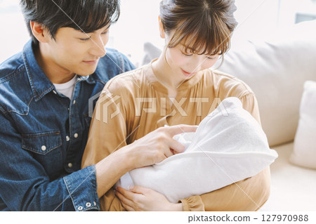 Mom and dad holding a baby Mom and dad holding a baby 127970988