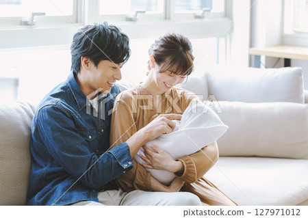 Mom and dad holding a baby Mom and dad holding a baby 127971012