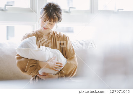 A young mother holding a baby 127971045