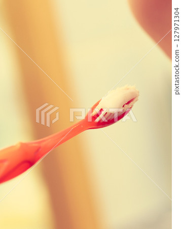Woman brushing her teeth 127971304