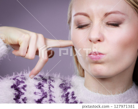 Woman covering ears with fingers Woman covering ears with fingers 127971381