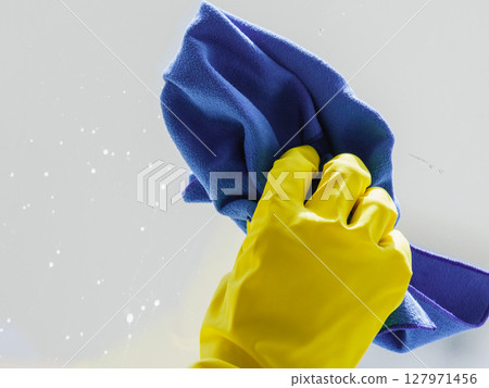 Person using cloth to clean window glass Person using cloth to clean window glass 127971456