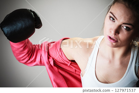 Sport boxer woman in black gloves boxing Sport boxer woman in black gloves boxing 127971537