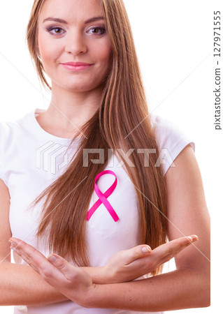 Woman wih pink cancer ribbon on chest Woman wih pink cancer ribbon on chest 127971555