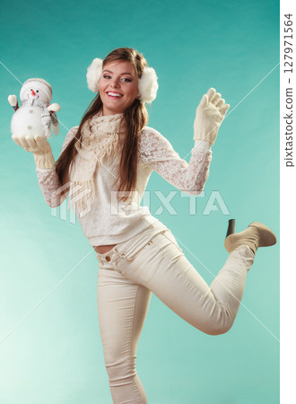 Smiling cute woman with little snowman. Winter. 127971564