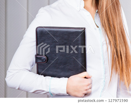 Young woman office worker hold case with files. Young woman office worker hold case with files. 127971590