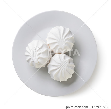 Round marshmallow on a plate on a white background. Top view 127971892