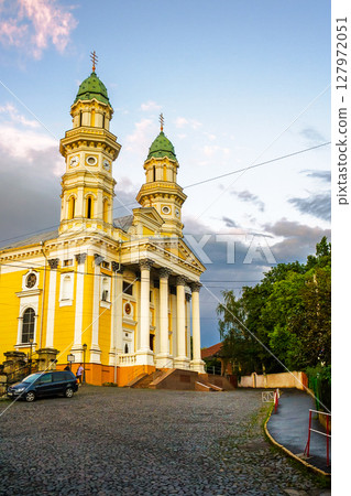 uzhhorod, ukraine - 9 jul 2012: exterior of holy cross greek catholic cathedral on the hill in evening light. beautiful baroque style architecture. prominent religious landmark of europe 127972051