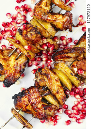 Grilled chicken wings, barbecue grilling kebabs. 127972120