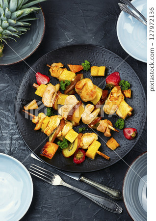 Meat skewers - grilled chicken breast and pineapple. 127972136