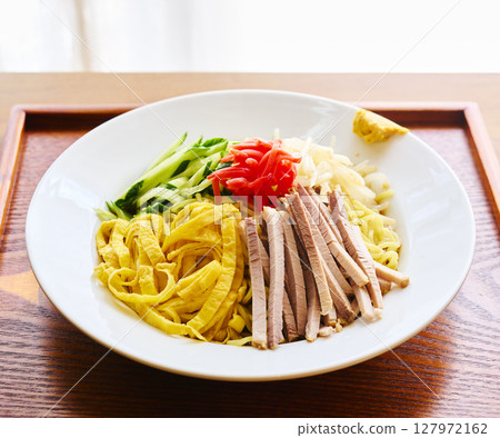 Cold Chinese noodles topped with colorful ingredients Cold Chinese noodles topped with colorful ingredients 127972162