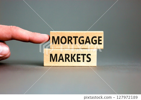 Mortgage markets symbol. Concept words Mortgage markets on beautiful wooden blocks. Beautiful grey table white background. Businessman hand. Business mortgage markets concept. Copy space. Mortgage markets symbol. Concept words Mortgage markets on beautiful wooden blocks. Beautiful grey table white background. Businessman hand. Business mortgage markets concept. Copy space. 127972189