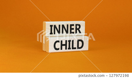 Inner child symbol. Concept words Inner child on beautiful wooden block. Beautiful orange table orange background. Psychological, motivational inner child concept. Copy space. Inner child symbol. Concept words Inner child on beautiful wooden block. Beautiful orange table orange background. Psychological, motivational inner child concept. Copy space. 127972198
