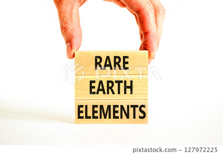 Rare earth elements symbol. Concept words Rare earth elements on beautiful wooden block. Businessman's hand. Beautiful white background. Business and rare earth elements concept. Copy space. Rare earth elements symbol. Concept words Rare earth elements on beautiful wooden block. Businessman's hand. Beautiful white background. Business and rare earth elements concept. Copy space. 127972225