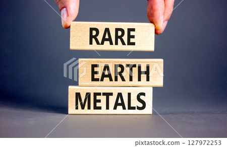 Rare earth metals symbol. Concept words Rare earth metals on beautiful wooden block. Businessman's hand. Beautiful grey background. Business and rare earth metals concept. Copy space. Rare earth metals symbol. Concept words Rare earth metals on beautiful wooden block. Businessman's hand. Beautiful grey background. Business and rare earth metals concept. Copy space. 127972253