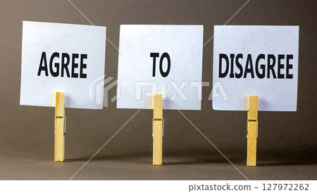Agree to disagree symbol. Concept words Agree to disagree on beautiful white paper on wooden clothespin. Beautiful grey background. Business and agree to disagree concept. Copy space. 127972262