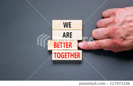 We are better together symbol. Concept words phrase We are better together on beautiful wooden blocks. Beautiful grey background. Businessman hand. Business We are better together concept. Copy space. 127972286