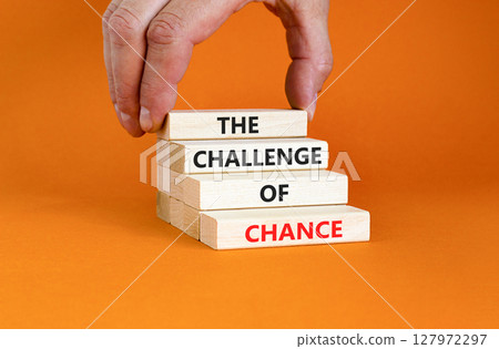 The challenge of chance symbol. Concept words phrase The challenge of chance on beautiful wooden blocks. Beautiful orange paper background. Business The challenge of chance concept. Copy space. The challenge of chance symbol. Concept words phrase The challenge of chance on beautiful wooden blocks. Beautiful orange paper background. Business The challenge of chance concept. Copy space. 127972297
