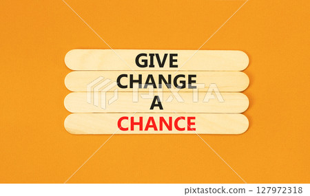 Give change a chance symbol. Concept words phrase Give change a chance on beautiful wooden stick. Beautiful orange paper background. Business Give change a chance concept. Copy space. 127972318