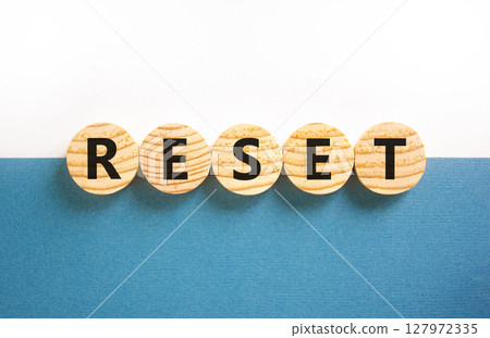 Reset symbol. Concept word Reset on beautiful wooden circles. Beautiful white and blue background. Business lifestyle reset concept. Copy space. 127972335