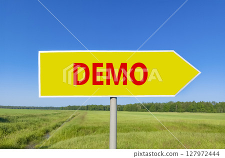 Demo symbol. Concept word Demo on beautiful yellow road sign. Beautiful blue sky green grass and forest peaceful nature background. Business and demo concept. Copy space. 127972444