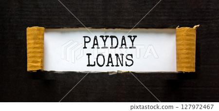 Payday loans symbol. Concept words Payday loans on beautiful white paper. Beautiful black paper cardboard background. Business and Payday loans concept. Copy space. 127972467