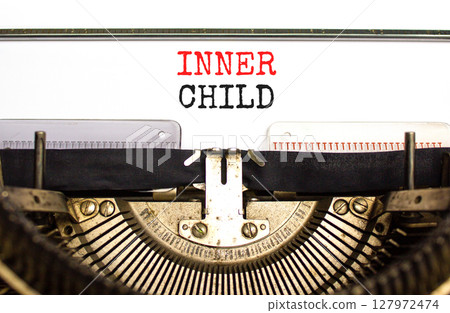 Inner child symbol. Concept words Inner child typed on beautiful old retro typewriter. Beautiful white paper background. Psychological, motivational inner child concept. Copy space. Inner child symbol. Concept words Inner child typed on beautiful old retro typewriter. Beautiful white paper background. Psychological, motivational inner child concept. Copy space. 127972474