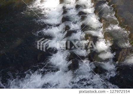 A small rapid for the ayu fish to swim upstream. A clear stream that has been regenerated naturally. 127972554