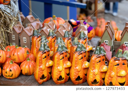 Halloween souvenirs and funny pumpkins and houses in a small shop Halloween souvenirs and funny pumpkins and houses in a small shop 127973433