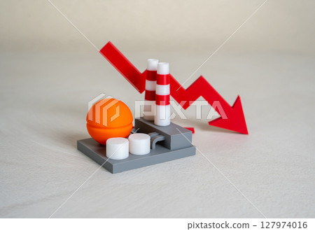 Industrial plant and red arrow down. Production decline, low revenue. Cost reduction. Credit rating decline. Crisis in industry. Economic downturn, job cuts, factory closures, declining orders. 127974016