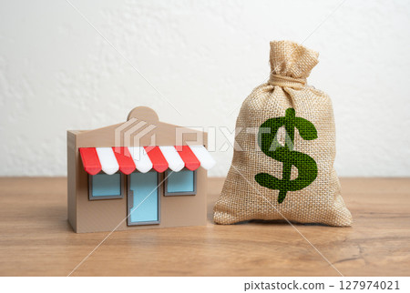 Shop and dollar money bag. Income and profit. Franchise revenue. Open your own business, borrow money. Retail profit, small business income, or the economic flow in local commerce. 127974021