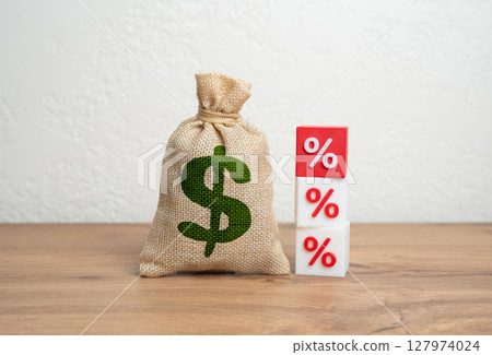 Dollar money bag and interest rates. Income taxes. Interest rates on loans. Fines and fees. Burden of debt, inflation. Personal finance, banking, and macroeconomic shifts. 127974024