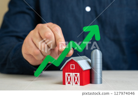 Man holding green growth arrow over farm. Growth of economy and revenue in agriculture. Investments and development. Technological adoption, rural revitalization, and sustainability in food production Man holding green growth arrow over farm. Growth of economy and revenue in agriculture. Investments and development. Technological adoption, rural revitalization, and sustainability in food production 127974046