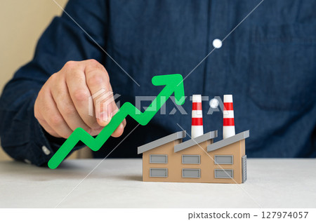 The man notes the economic growth of the factory industry. Increase in production. Rising GDP, higher employment, and strong sector performance. National economic indicators. The man notes the economic growth of the factory industry. Increase in production. Rising GDP, higher employment, and strong sector performance. National economic indicators. 127974057